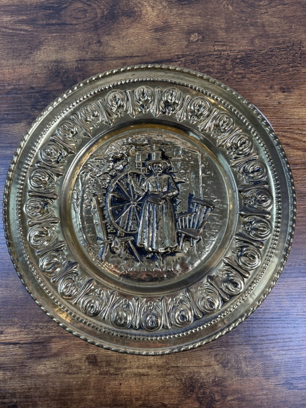Decorative Embossed Brass Wall Plate with Spinning Wheel Motif